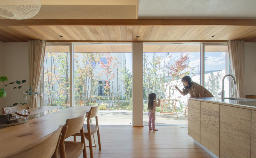 庭に面した木の住まいで過ごす親子